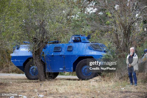 Protester stands near an armored vehicle of Gendarmerie Mobile . Protesters decided to create a ZAD in a farm 'La Cremade' nearby before being...