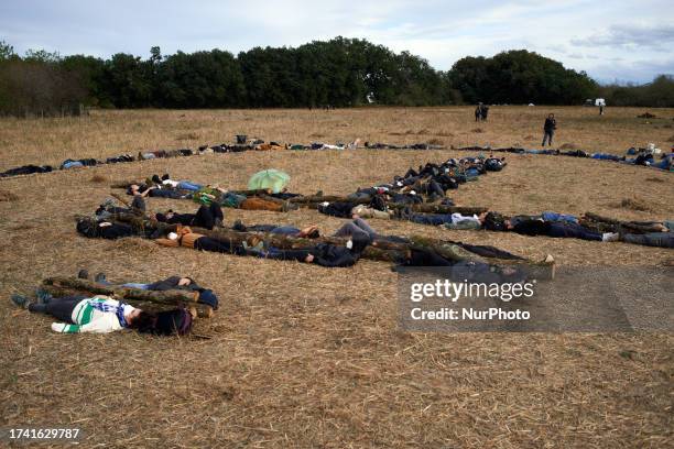 Protesters drawed the symbol of the collective 'Les Soulevements de la Terre' with their bodies and trees cut for the building of the A69 highway....