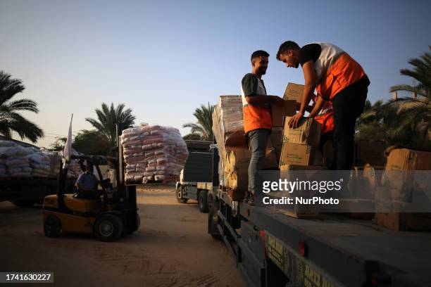 Red Crescent workers sort aid before being distributed to Palestinians, as the conflict between Israel and Palestinian Islamist group Hamas...