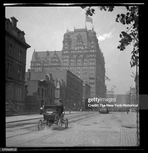 34th Street looking west toward the Waldorf Astoria on Fifth Avenue, early automobile in foreground, New York, New York, late 19th or early 20th...