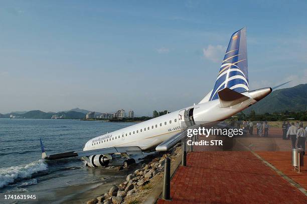 An Aerorepublica airlines' Embraer 190 aircraft sits nose down on a beach bank 17 July, 2007 in Santa Marta, department of Magdalena, Colombia. Nine...