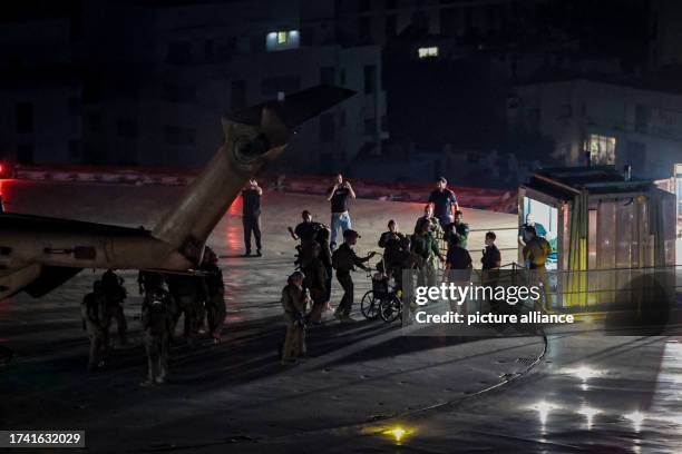 October 2023, Israel, Tel Aviv: One of the freed hostages in a wheelchair disembarks from a military helicopter after landing on the roof of Ichilov...