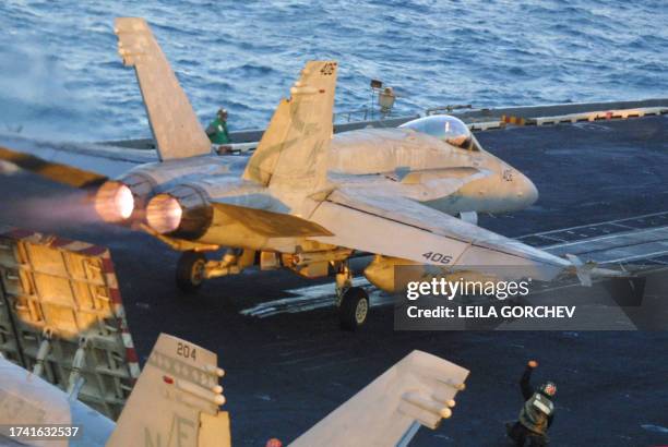 An F-18 Hornet takes off from the USS Constellation 26 December 2002 in Gulf waters. The USS Constellation is conducting operations to help enforce...