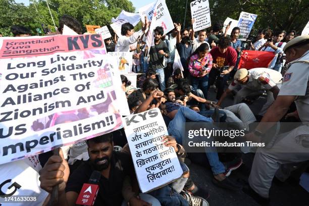 Security personnel detain Students Federation of India activists during a demonstration in solidarity with Palestinians, at Embassy of Israel on...