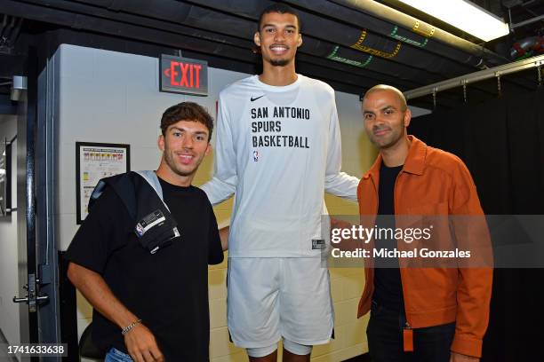 Legend Tony Parker, Victor Wembanyama of the San Antonio Spurs, and French Formula One Racing Driver Pierre Gasly pose for a photo before the game on...