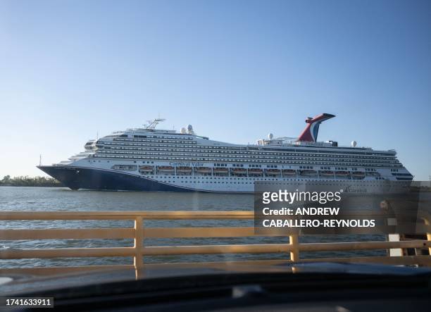 Carnival cruise ship heads to the Gulf of Mexico as it passes a car ferry on the Mississippi river south of New Orleans, Louisiana on October 16,...