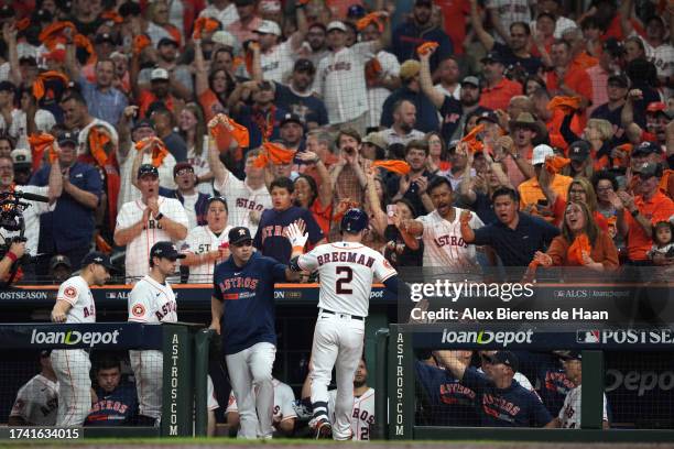 Alex Bregman of the Houston Astros celebrates with hitting coach Alex Cintron after hitting a home run in the third inning during Game 7 of the ALCS...