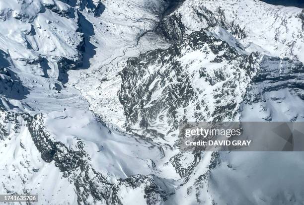 In this photo taken on October 18 snow covers mountains in the Mount Aspiring National Park located near Queenstown on the South Island of New...