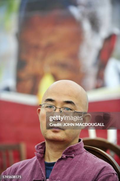 Chinese dissident writer Liao Yiwu poses for photographers prior to a press conference in Berlin on September 16, 2010. Liao, who was prevented by...