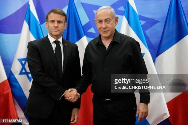 Israeli Prime Minister Benjamin Netanyahu greets French President Emmanuel Macron before a meeting in Jerusalem on October 24, 2023. Macron's visit...