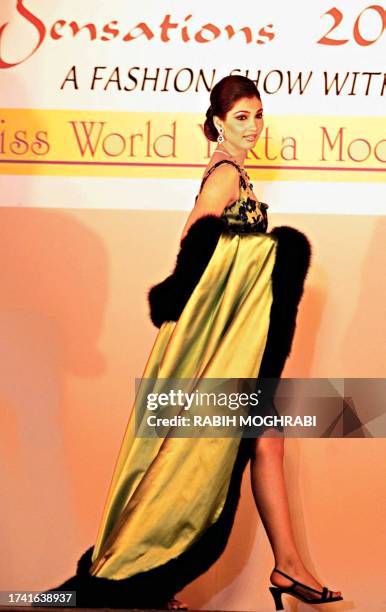 Miss World Yukta Mookhey of India models an evening dress during a fashion show organized by Damas Sensations 2000 in Dubai 15 March 2000.