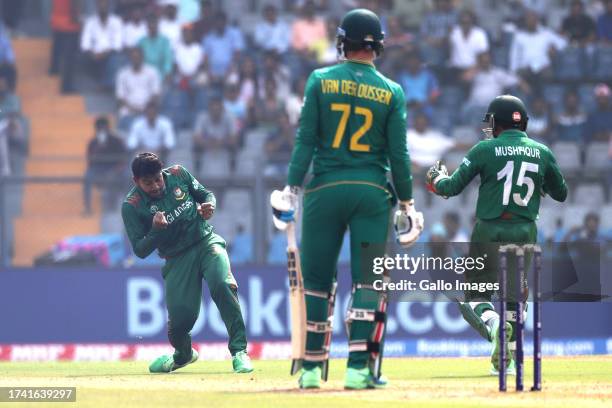 Mehidy Hasan Miraz of Bangladesh celebrates the wicket of Rassie van der Dussen of South Africa during the ICC Men's Cricket World Cup 2023 match...