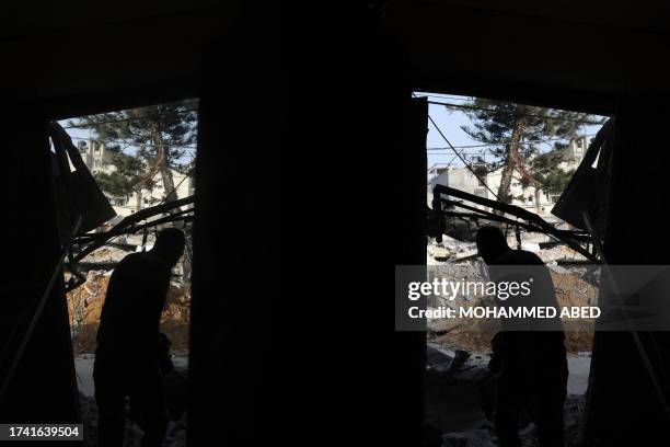 Man inspects a damaged hairdresser's shop following Israeli strikes on Rafah in the southern Gaza Strip on October 24 amid ongoing battles between...