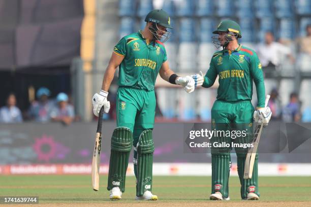 Aiden Markram of South Africa and Quinton de Kock of South Africa interact during the ICC Men's Cricket World Cup 2023 match between South Africa and...