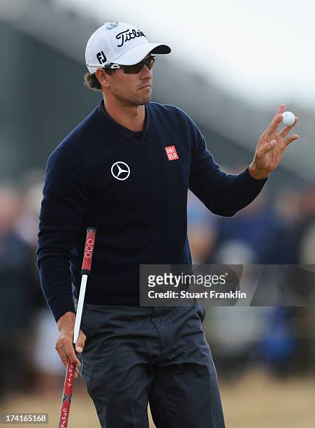 Adam Scott of Australia acknowledges the crowd on the 10th green during the final round of the 142nd Open Championship at Muirfield on July 21, 2013...