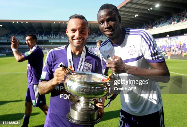 Anderlecht's Demy De Zeeuw and Cheikhou Kouyate celebrate with their trophy after winning the Belgian Supercup football match against RC Genk, on...