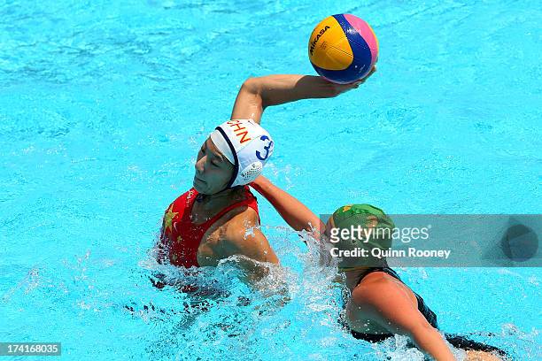 Liu Ping of China passes the ball under pressure from Kieran Paley of South Africa during the Women's Water Polo first preliminary round match...