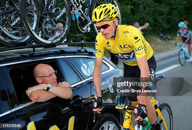 Procycling General Manager Sir Dave Brailsford speaks with the winner of the 2013 Tour de France, Chris Froome of Great Britain and SKY during the...