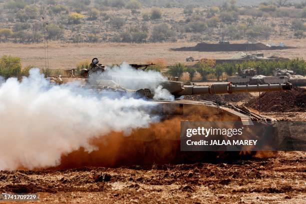 An Israeli Merkava tank takes part in a military drill near the border with Lebanon in the upper Galilee region of northern Israel on October 24,...