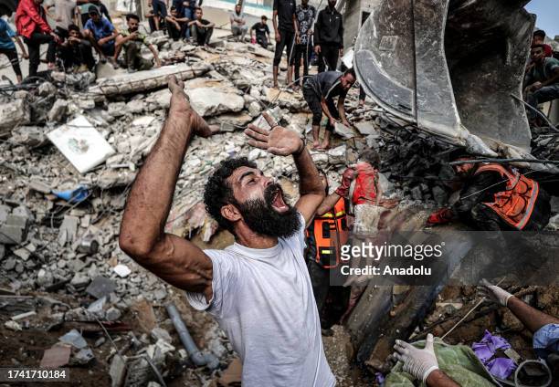 Palestinian man mourns as civil defense teams and residents conduct a search and rescue operation for Palestinians stuck under the debris of a...