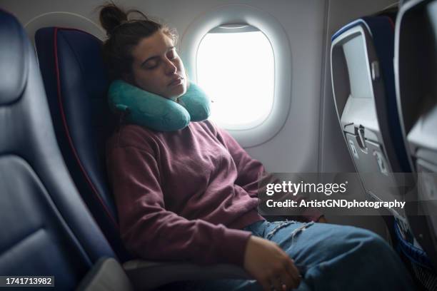 taking a nap in the airplane while traveling. - neck pillow stock pictures, royalty-free photos & images