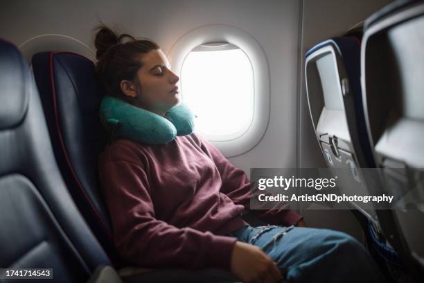 woman on airplane sleeping while flying. - offline mode stock pictures, royalty-free photos & images