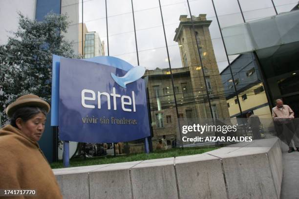 Bolivian Aymara woman passes by the Entel building 23 April, 2007 in La Paz. The Bolivian government on Monday ordered two private pension funds to...