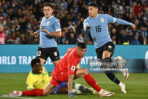 Manuel Ugarte , Sergio Rochet and Mathias Olivera of Uruguay compete for the ball with Vinicius Jr. Of Brazil during the FIFA World Cup 2026...