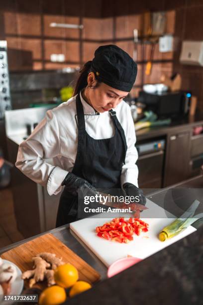 waist up portrait of female chef dicing lettuce - glove stock pictures, royalty-free photos & images