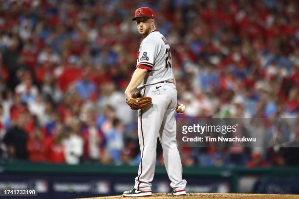 Merrill Kelly of the Arizona Diamondbacks checks first base in the first inning while playing the Philadelphia Phillies during Game Two of the...
