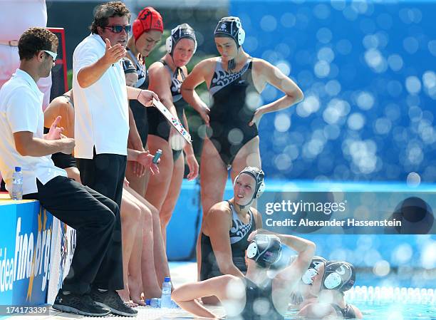 Coach Attila Biro of New Zealand talks to his team during a break in the Women's Water Polo first preliminary round match between Australia and New...