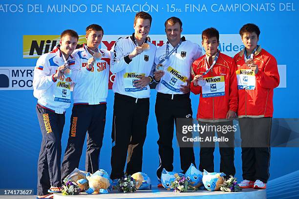 Medallists Victor Minibaev and Artem Chesakov of Russia , Patrick Hausding and Sascha Klein of Germany and Zhang Yanguan and Cao Yuan of China pose...