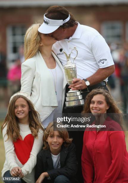 Phil Mickelson of the United States kisses wife Amy with children Evan, Amanda and Sophia after winning the 142nd Open Championship at Muirfield on...