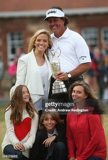 Phil Mickelson of the United States holds the Claret Jug wife Amy and children Evan, Amanda and Sophia after winning the 142nd Open Championship at...