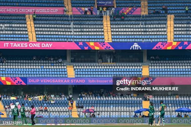 Spectators watch the 2023 ICC Men's Cricket World Cup one-day international match between South Africa and Bangladesh at the Wankhede Stadium in...