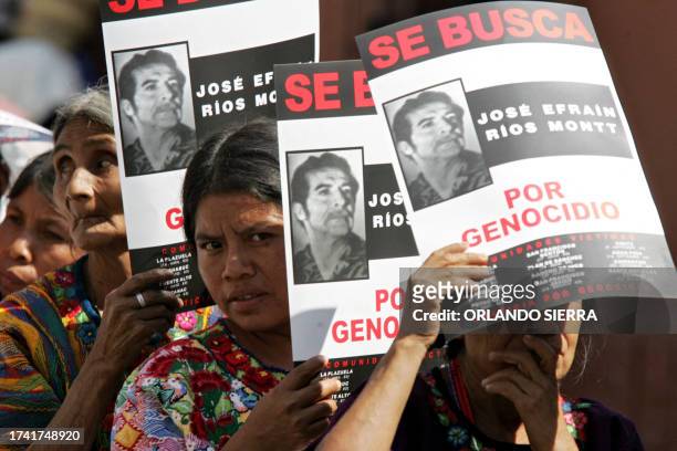 Relatives of the victims of the 1960-1996 civil war show posters of former Guatemalan dictator Efrain Rios Montt during a protest rally in Guatemala...