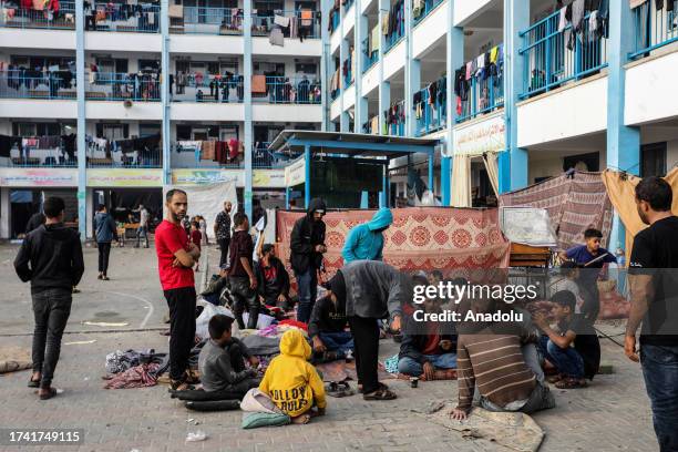 Injured Palestinians and their families take shelter in a school of the United Nations Relief and Works Agency for Palestine Refugees in the Near...