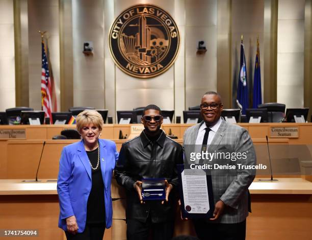 Las Vegas Mayor Carolyn Goodman, Usher and Las Vegas City Councilman Cedric Crear pose for a photo during a ceremony honoring Usher at Las Vegas City...