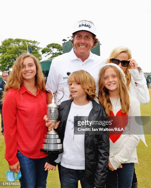 Phil Mickelson of the United States holds the Claret Jug with wife Amy and children Evan, Amanda and Sophia after winning the 142nd Open Championship...