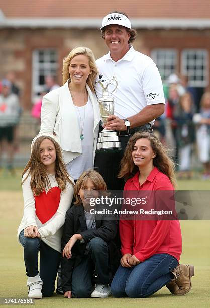 Phil Mickelson of the United States holds the Claret Jug wife Amy and children Evan, Amanda and Sophia after winning the 142nd Open Championship at...