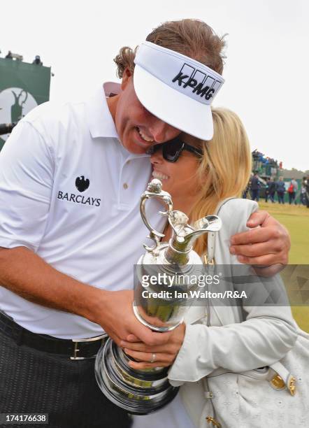 Phil Mickelson of the United States hugs wife Amy while holding the Claret Jug after winning the 142nd Open Championship at Muirfield on July 21,...