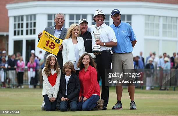 Phil Mickelson of the United States holds the Claret Jug wife Amy and children Evan, Amanda and Sophia.former coach Steve Loy, coach Butch Harmon and...