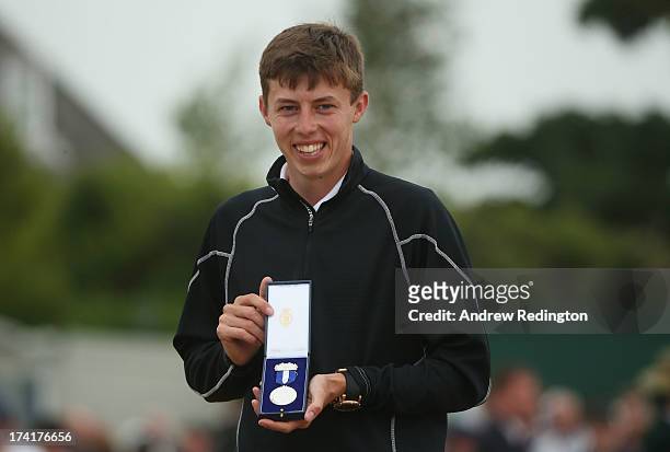 Matthew Fitzpatrick of England holds the silver medal for the leading amateur player during the final round of the 142nd Open Championship at...