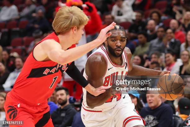 Patrick Williams of the Chicago Bulls drives to the basket against Gradey Dick of the Toronto Raptors during the first half at the United Center on...
