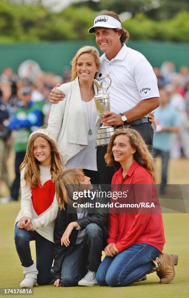 Phil Mickelson of the United States holds the Claret Jug with wife Amy and children Evan, Amanda and Sophia after winning the 142nd Open Championship...