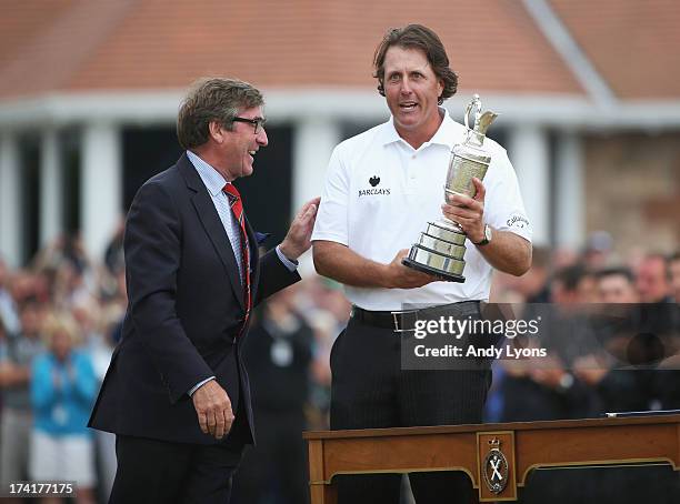 Phil Mickelson of the United States is presented with the Claret Jug by Captain of Muirfield, Robin Dow after winning the 142nd Open Championship at...