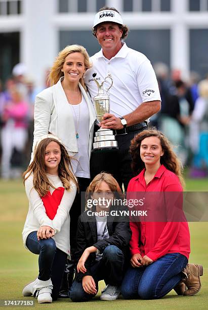 Golfer Phil Mickelson poses for pictures with his wife Amy and children Evan Samuel, Amanda Brynn and Sophia Isabel after winning the 2013 British...