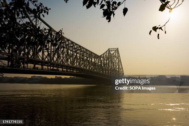 The Hooghly river and the iconic Howrah bridge are seen in the morning.