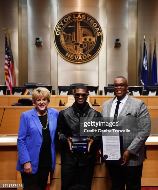 Las Vegas Mayor Carolyn Goodman, Usher and Las Vegas City Councilman Cedric Crear pose for a photo during a ceremony honoring Usher at Las Vegas City...