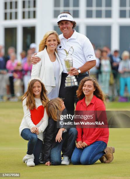 Phil Mickelson of the United States holds the Claret Jug with wife Amy and children Evan, Amanda and Sophia after winning the 142nd Open Championship...